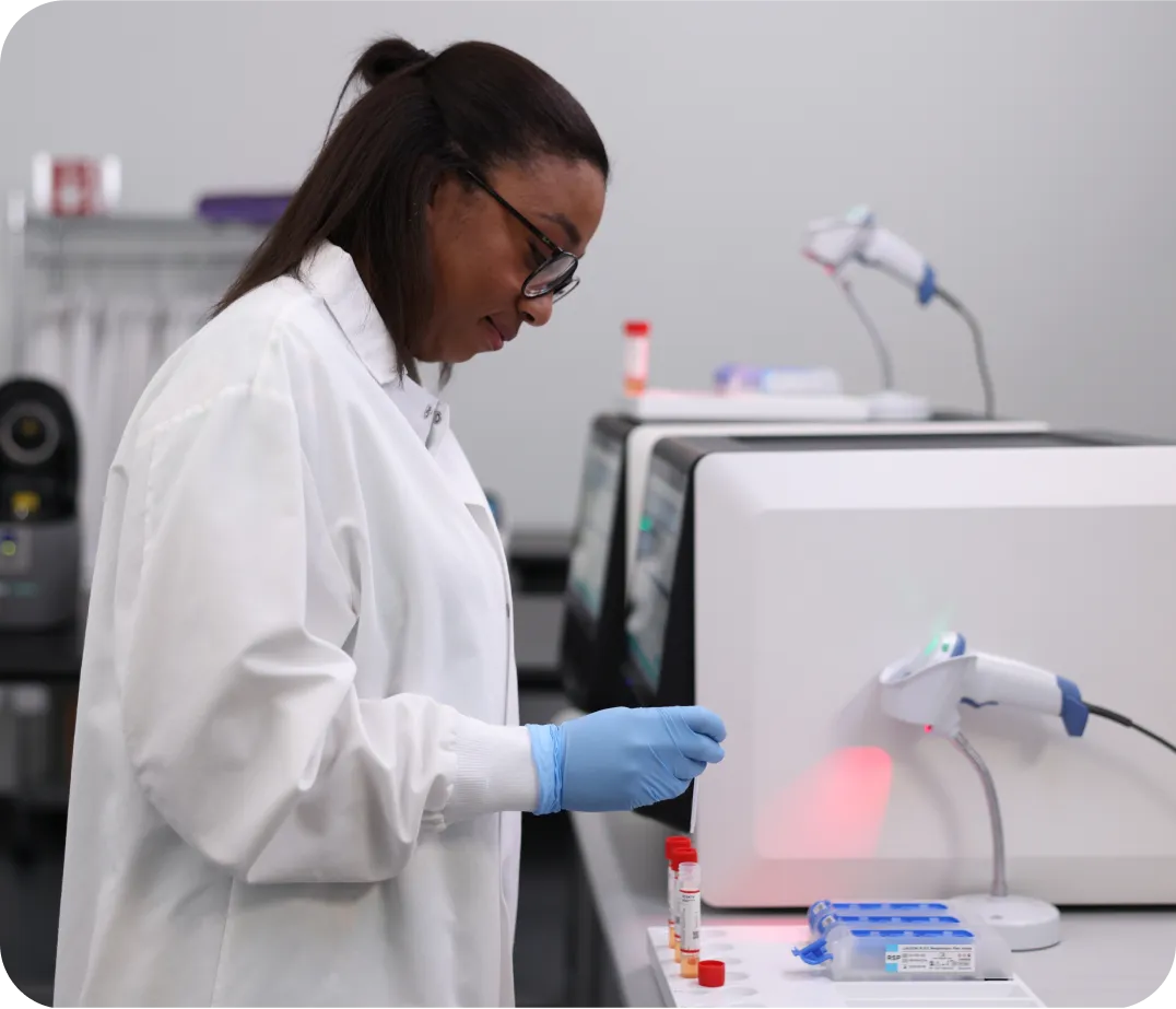 black woman using a liaison plex machine in the lab