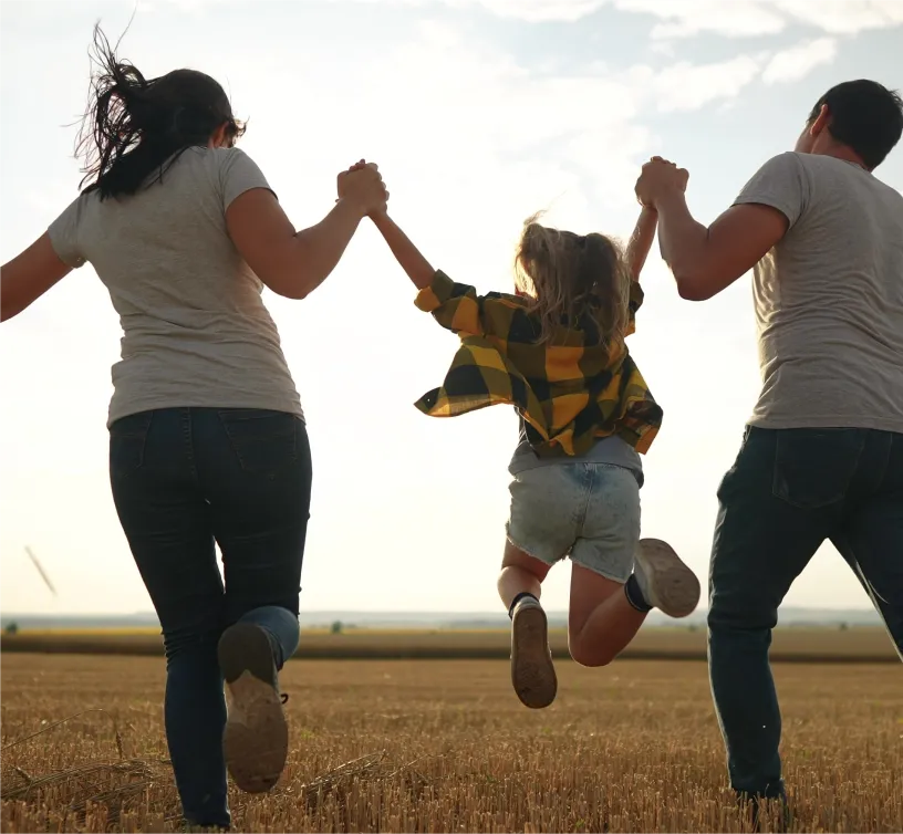 mother father and daughter in wheat field